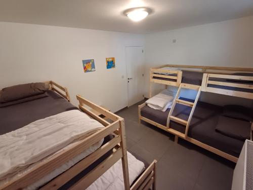 a dorm room with two bunk beds in it at Chalet Jarte in Barvaux