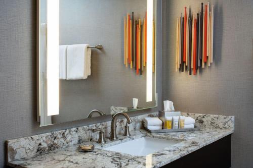 a bathroom with a sink and a large mirror at Golden Nugget Lake Tahoe in Stateline