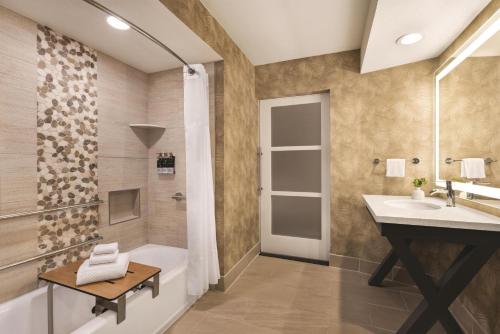 a bathroom with a sink and a shower at Zachari Dunes on Mandalay Beach, Curio Collection by Hilton in Oxnard