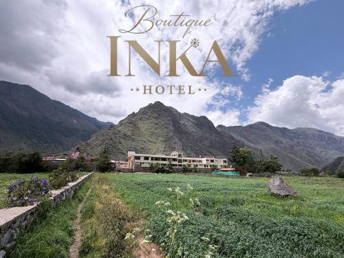 a sign for a hotel with a mountain in the background at Boutique Inka Hotel in Ollantaytambo