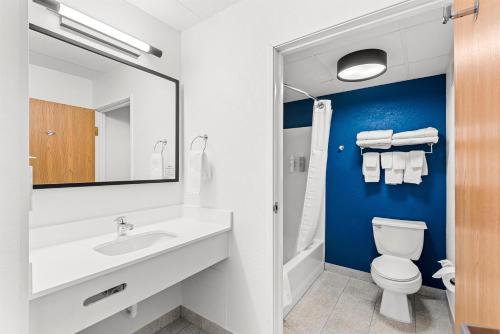 a bathroom with a sink and a toilet at Spark by Hilton Cedar Falls in Cedar Falls