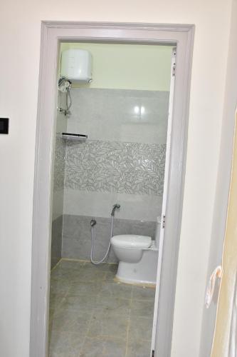 a bathroom with a toilet in a room at Beach Flat in Bhīmunipatnam