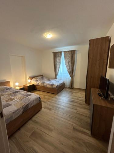 a hotel room with two beds and a television at Casa Cianetta in San Dorligo della Valle