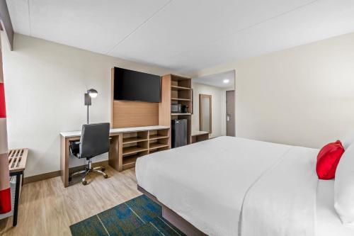 a hotel room with a large bed and a desk at Sonesta Select Hotels Statesville in Statesville