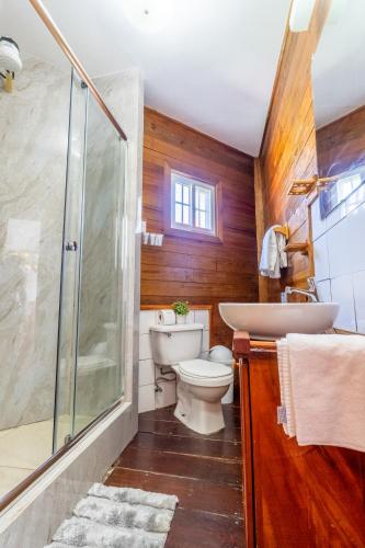a bathroom with a toilet and a shower and a sink at Faro del Colibri in Bocas Town