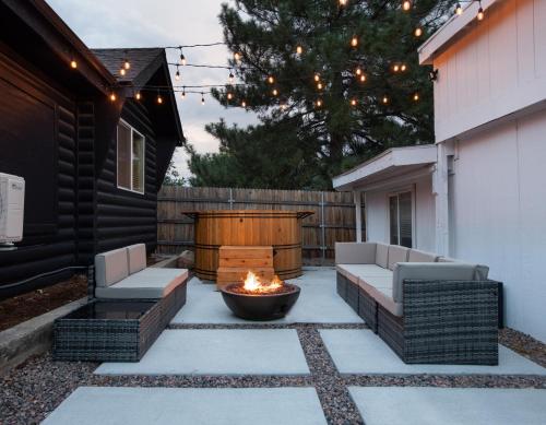 a patio with two couches and a fire pit at Mid-Century Modern Home - Hot Tub and Game Room in Denver