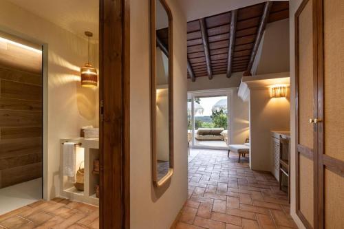 a hallway of a home with a door and a mirror at Herdade do Sobroso Wine Hotel & Villas - Small Luxury Hotels of the World in Pedrógão