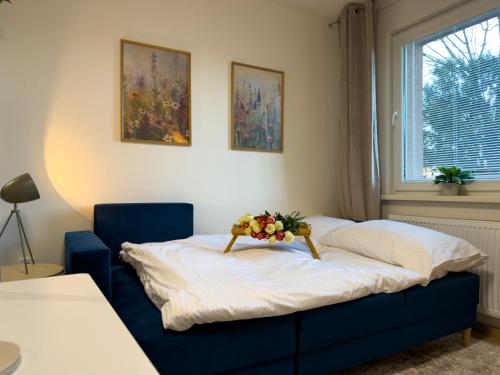 a bedroom with a bed with a flower arrangement on it at The Minimalist Suite in Šurany