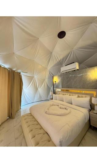 a bedroom with a large bed in a tent at Wadi rum lacshre in Disah