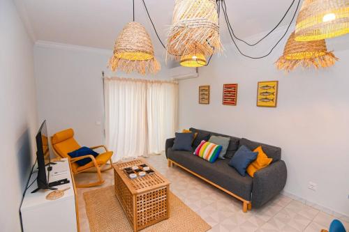 a living room with a couch and a table at Três Sardinhas in Vila Praia de Âncora