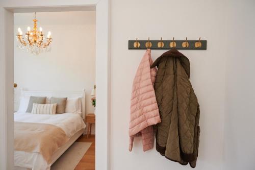 a bedroom with a bed and a chandelier at TORTORELLA Apartments in Gorizia