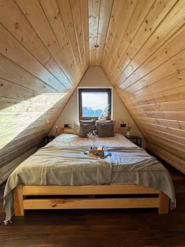a bedroom with a large bed in a attic at Koperkowe Domki Zakopane in Zakopane