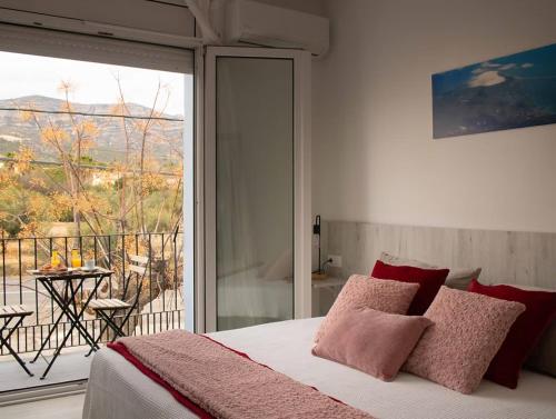 a bedroom with a bed and a balcony with a view at bahia montecarlo in Les Cases d'Alcanar