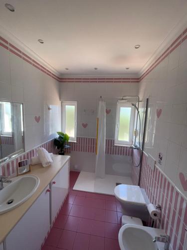 a bathroom with a sink and a toilet and a shower at Casa Luar- suite rooms in Praia do Carvoeiro