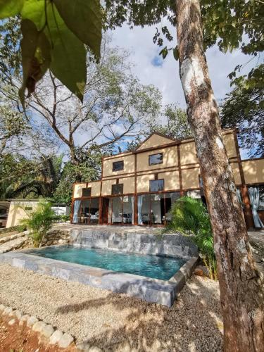 a house with a swimming pool in front of it at Villa Palladio Carrillo in Hojancha