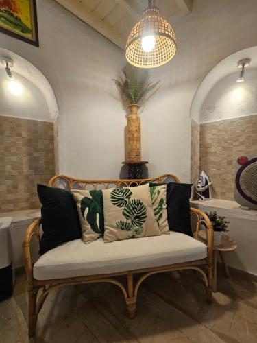 a couch in a room with a pendant light at Capparis Studio in Mikonos