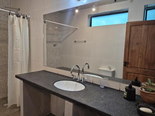 a bathroom with a sink and a mirror at Manipa Loft 2 in Cafayate