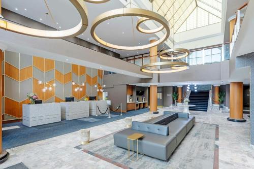 an office lobby with a large chandelier at Sandman Signature Mississauga Hotel in Mississauga