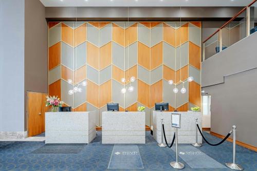a lobby with a wall with a geometric pattern at Sandman Signature Mississauga Hotel in Mississauga