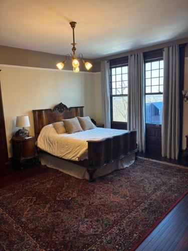 a bedroom with a large bed and a large window at Alden Villa in Lebanon