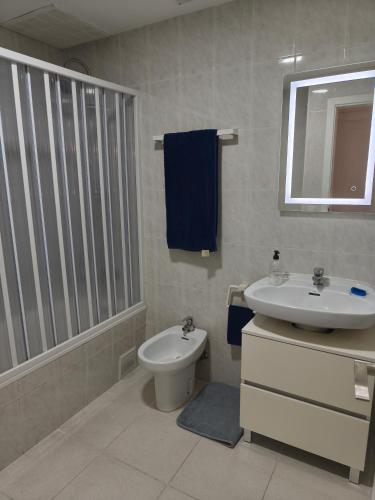 a bathroom with a toilet and a sink at Apartamento Blanes Vela Port in Blanes