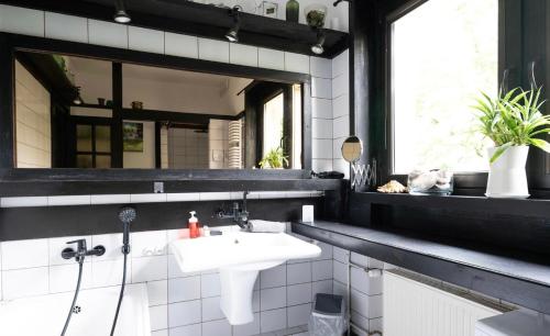 a bathroom with a sink and a mirror at Unique House with private swimming pool by the sea - AFRA GROUP in Sopot