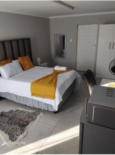 a bedroom with a bed and a desk with a printer at Little Waters Bnb in Queenstown