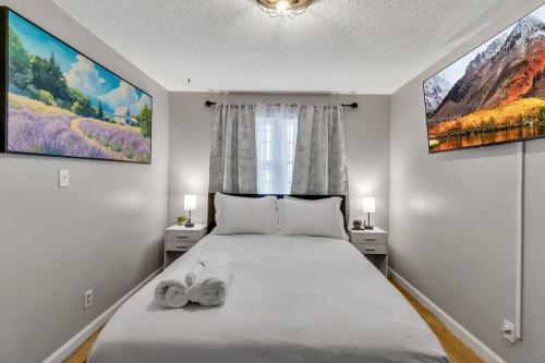 a bedroom with a bed with two towels on it at New 3BDRM Centrally Located Free Parking AC in Buffalo