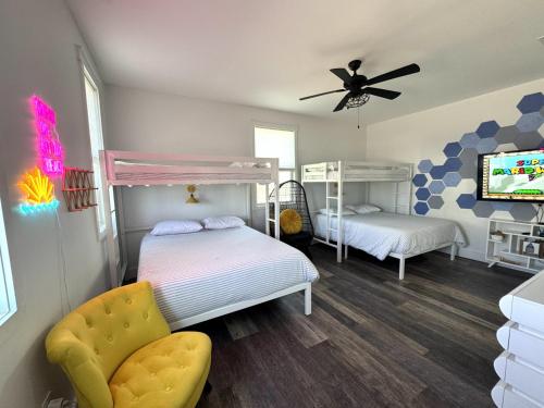 a bedroom with two bunk beds and a ceiling fan at Simply Adventurous in Mexico Beach