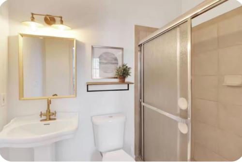 a bathroom with a toilet and a sink and a shower at Simply Adventurous Too in Mexico Beach