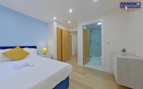 a bedroom with a bed and a walk in shower at Beauchamp House - 2-bed apartment in Coventry City Centre, Free Parking, by COVSTAYS in Coventry