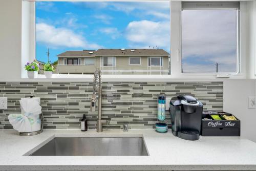 a kitchen sink in front of a window at 3BR Queen Anne House with Rooftop access in Seattle