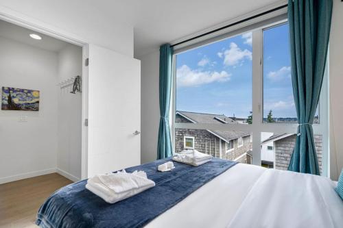 a bedroom with a large window and a bed at 3BR Queen Anne House with Rooftop access in Seattle