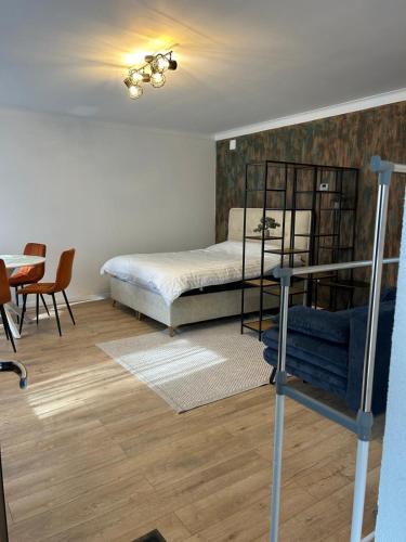 a bedroom with a bed and a table and chairs at Nicotel in Turda