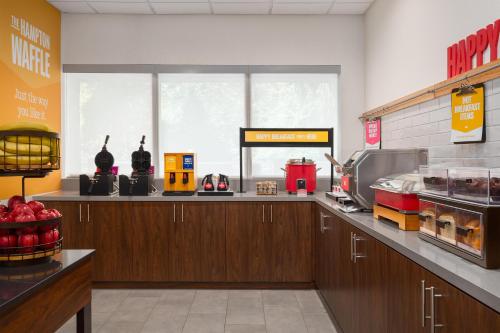 a kitchen with a counter in a fast food restaurant at Hampton Inn & Suites Charlotte Arrowood Rd in Charlotte