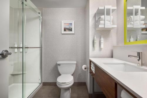 a bathroom with a toilet and a sink and a shower at Hampton Inn & Suites Charlotte Arrowood Rd in Charlotte