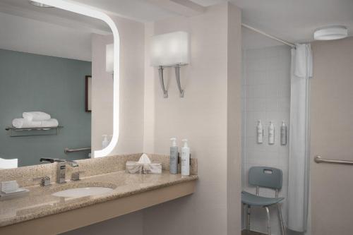 a bathroom with a sink and a mirror at Homewood Suites by Hilton Raleigh/Cary in Cary