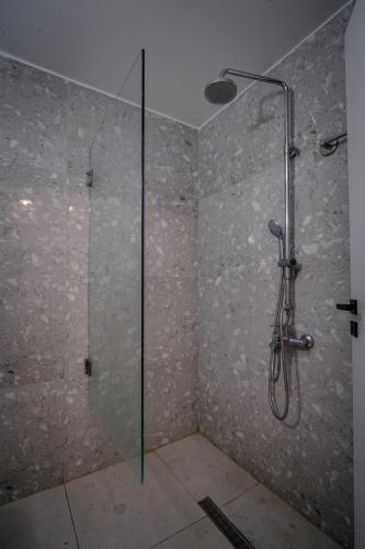 a shower with a glass door in a bathroom at PEARL BOUTIQUE Hotel BEACH ROAD MALIA in Malia