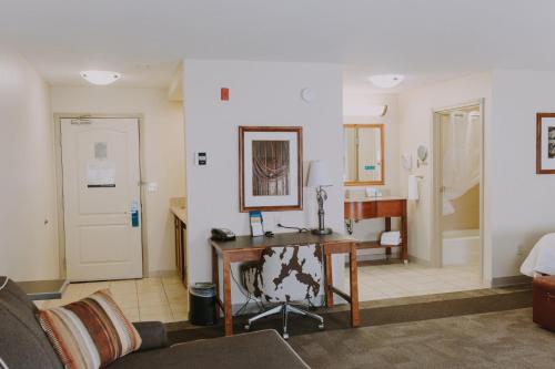 a living room with a desk and a bathroom at Hampton Inn & Suites Green River in Green River