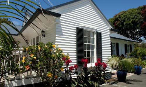 a white house with flowers in front of it at Seaport Village in Russell