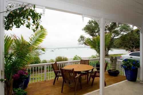 a porch with a table and chairs and a view of the ocean at Seaport Village in Russell