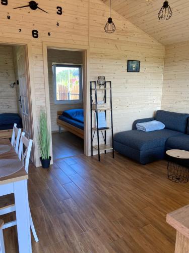a living room with a couch and a bunk bed at Domki pod Dębem in Wilkasy