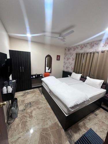 a bedroom with a large bed and a television at Anand Kanan in Varanasi