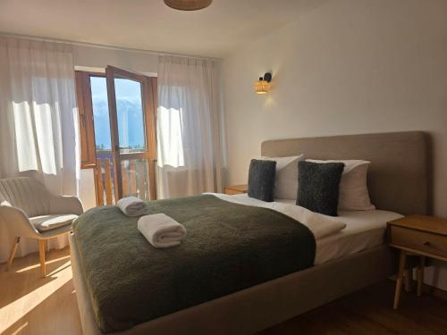 a bedroom with a large bed with towels on it at La Kozica in Kościelisko