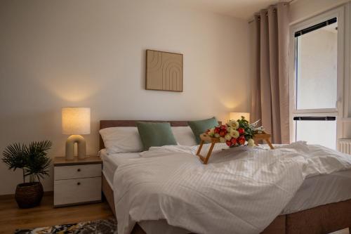 a bedroom with a bed with a flower arrangement on it at The Elegant Hideaway in Šurany