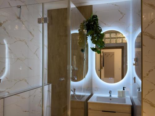 a bathroom with a sink and a mirror at The Elegant Hideaway in Šurany
