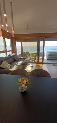 a living room with a couch and a table at NEW Sunset Suite in Povljana