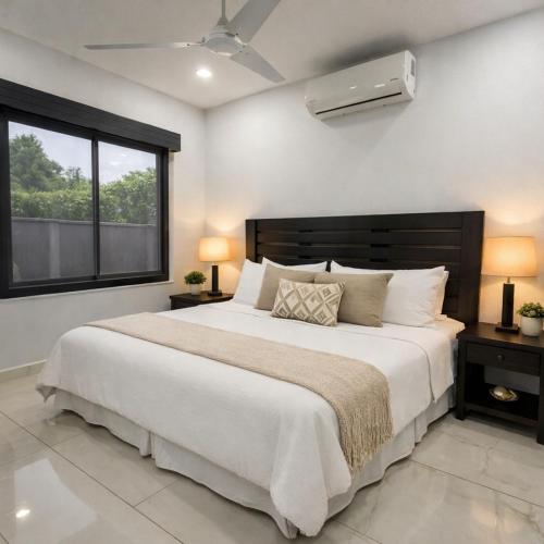 a bedroom with a large bed and a window at Casamar in Uvita