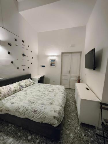 a bedroom with a bed and a flat screen tv at Due Monelli in Naples