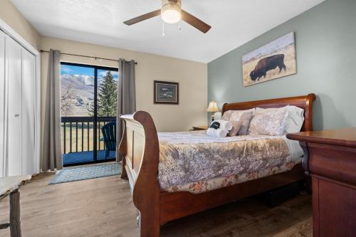 a bedroom with a bed and a sliding glass door at Sigi's Longhorn Lodge WL1409 Gym Ski Powder Mtn in Eden